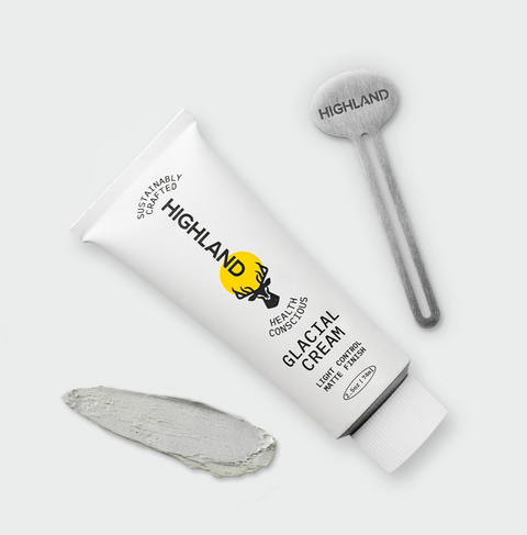 Tube of HIGHLAND skincare cream, round applicator labeled HIGHLAND, and a gray product smear on light gray background.