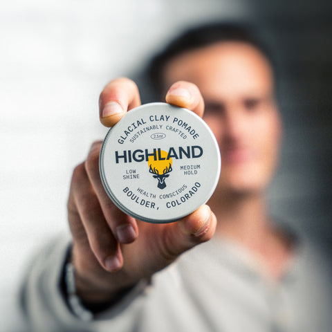 Highland co-founder Ben Medalie holding a tin of Glacial Clay Pomade