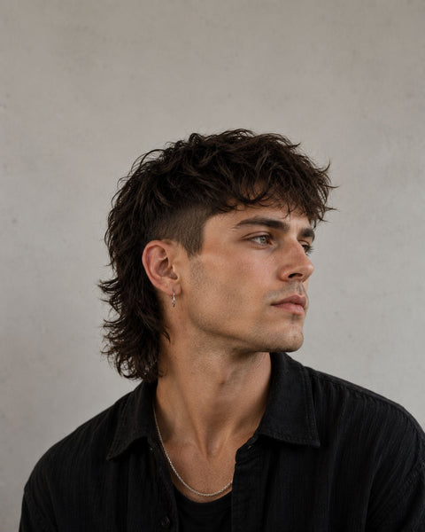 man wearing black shirt with a mullet