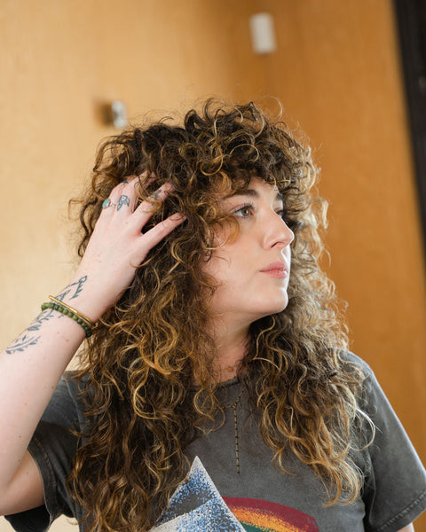 Woman with perm hair looking away from camera