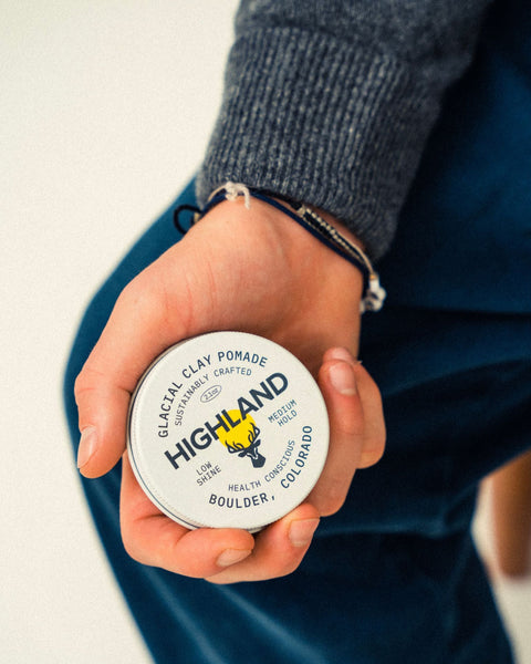 man han holding highland glacial clay pomade