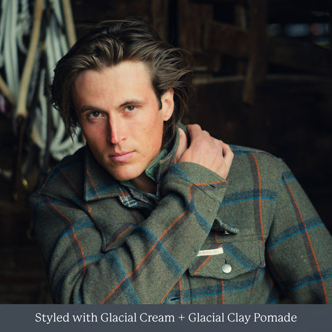 Man with short brown hair wearing a green plaid jacket; caption reads: Styled with Glacial Cream + Glacial Clay Pomade