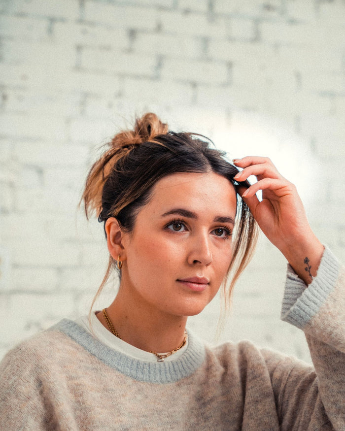 Woman with color treated hair in a bun