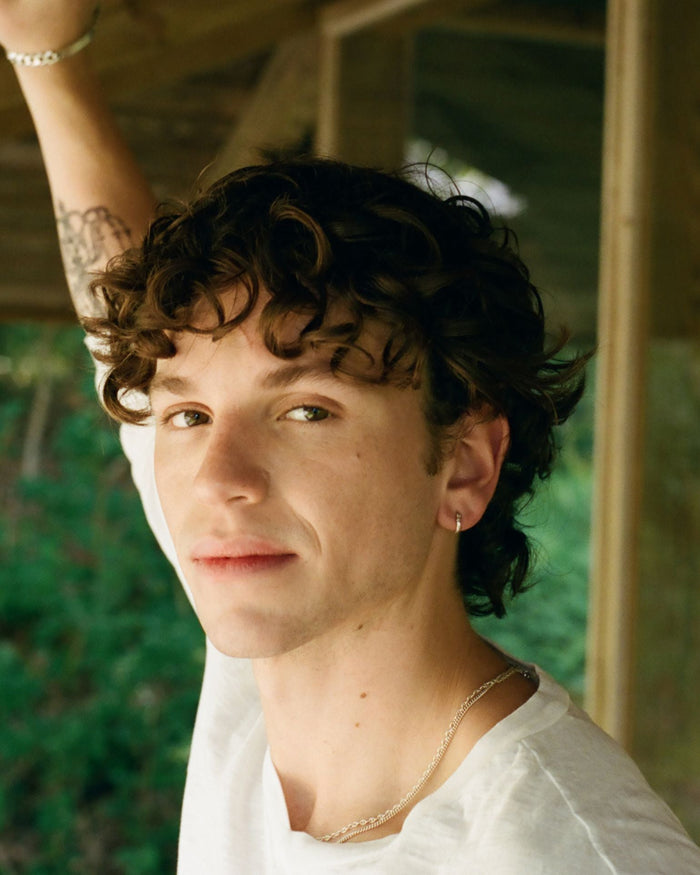 man wearing white shirt with a modern mullet