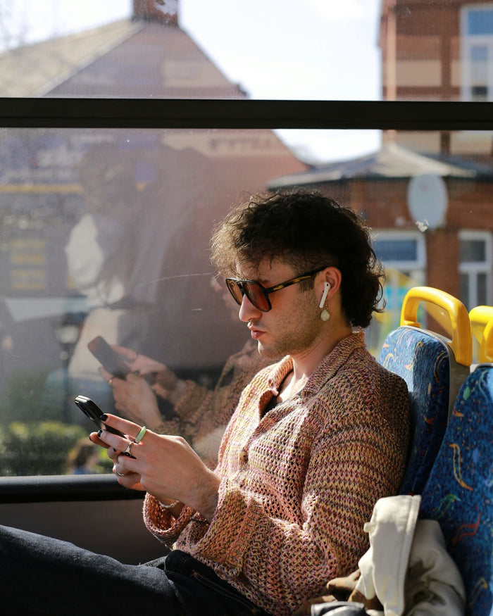 man with mullet riding on bus