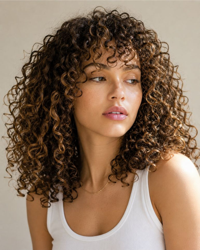 Woman with perm hair looking away from camera 