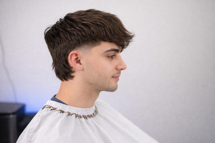 Side profile of a man with a medium mullet