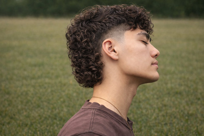 Side profile of a man with a modern perm mullet