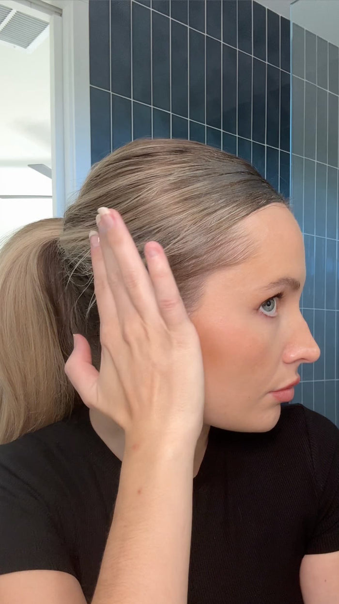 Side profile of a woman with a slick back look