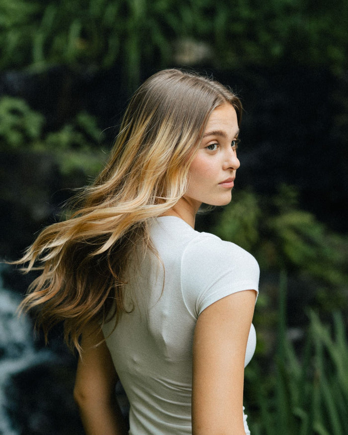 woman with bronde wavy hair turning head