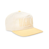 Cream baseball cap with pale yellow curved brim and tonal raised ribbed lettering on front