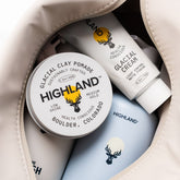 Open view of Highland Dopp Kit showcasing its spacious interior filled with Highland grooming products against a light background
