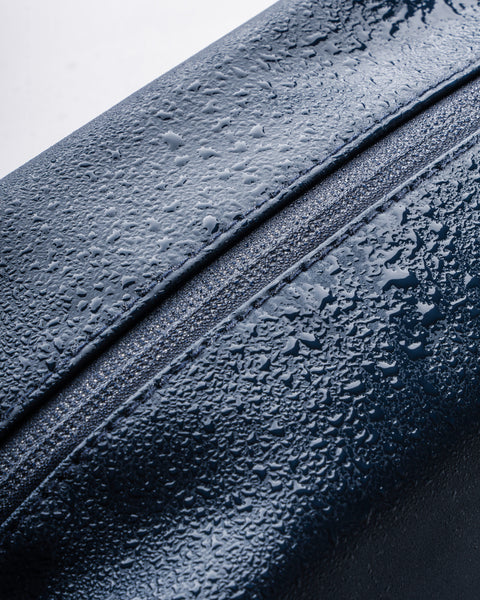 Close-up of Highland Dopp Kit in Slate showcasing water resistant material with water droplets