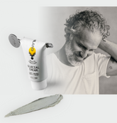Angled tube of Glacial Cream showing matte finish label with a smear of cream and a smiling man in grayscale