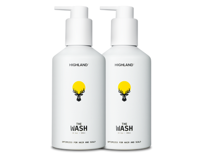Two white pump bottles labeled HIGHLAND, THE WASH, OPTIMIZED FOR HAIR AND SCALP with yellow sun-and-deer logo.